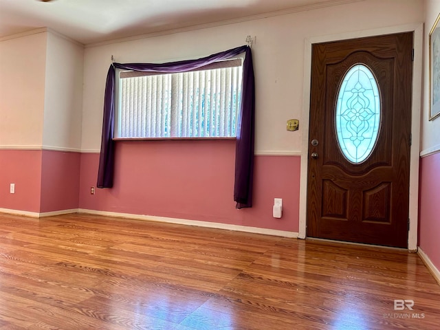 foyer featuring hardwood / wood-style floors and crown molding