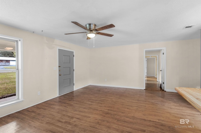 empty room featuring dark hardwood / wood-style floors and ceiling fan