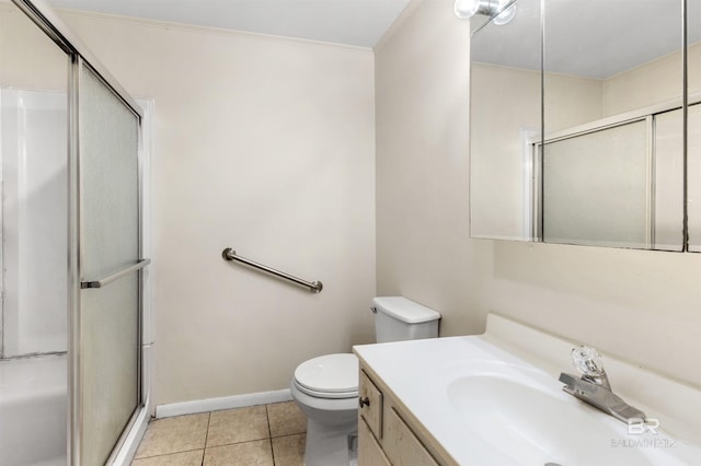 bathroom featuring vanity, tile patterned floors, toilet, ornamental molding, and walk in shower