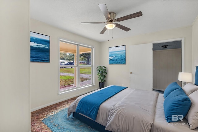 bedroom with a textured ceiling and ceiling fan