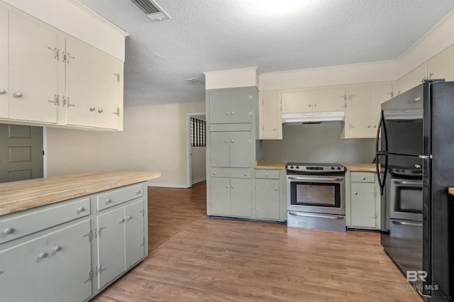 kitchen featuring a textured ceiling, light hardwood / wood-style floors, black fridge, and electric stove