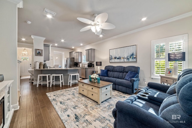 living area with crown molding, recessed lighting, wood-type flooring, visible vents, and ceiling fan