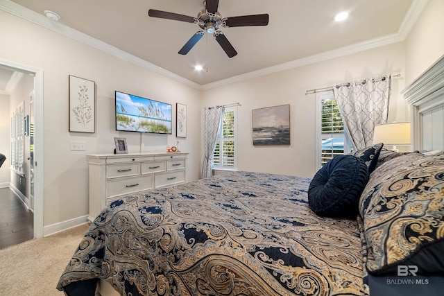 bedroom featuring ornamental molding, multiple windows, carpet, and baseboards