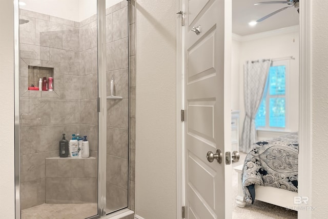 bathroom with a stall shower, a ceiling fan, and crown molding