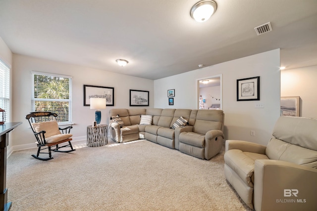 carpeted living area with visible vents and baseboards