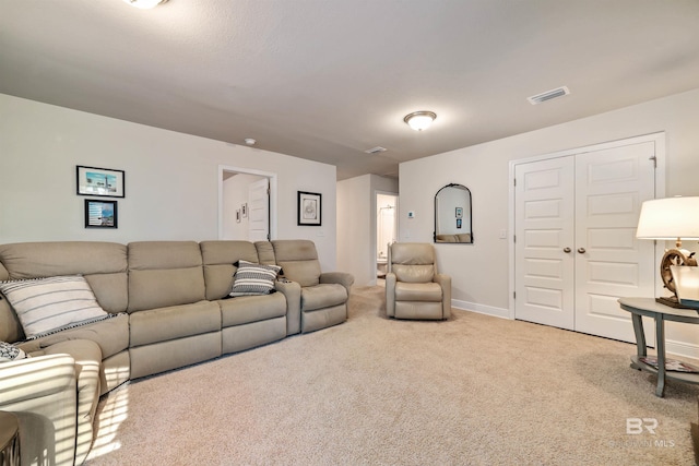 living area featuring carpet floors, visible vents, and baseboards