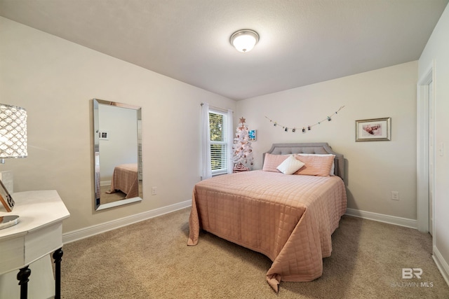 bedroom featuring baseboards and carpet flooring