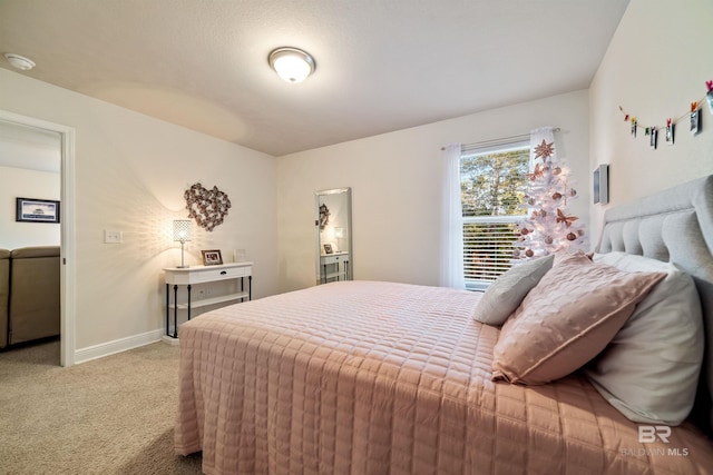 carpeted bedroom featuring baseboards