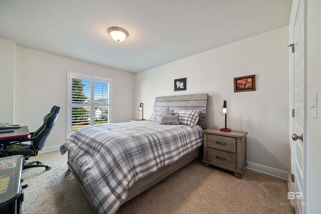 bedroom featuring light carpet and baseboards