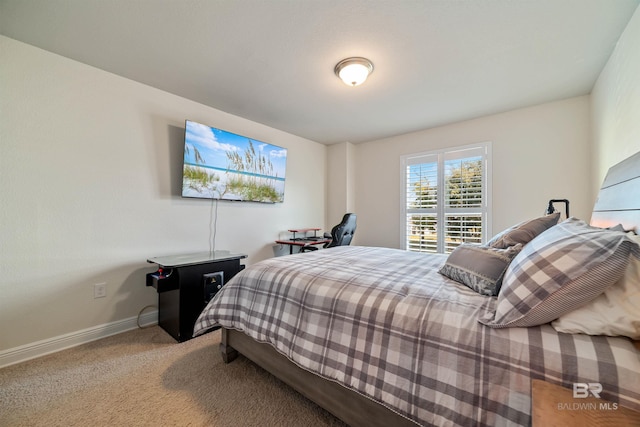 bedroom with carpet flooring and baseboards