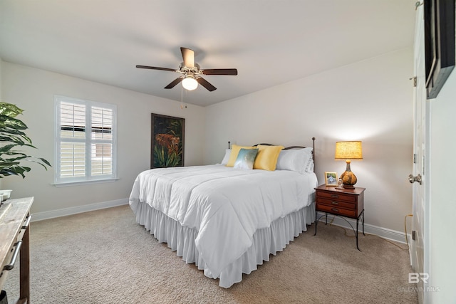 bedroom with baseboards, a ceiling fan, and light colored carpet