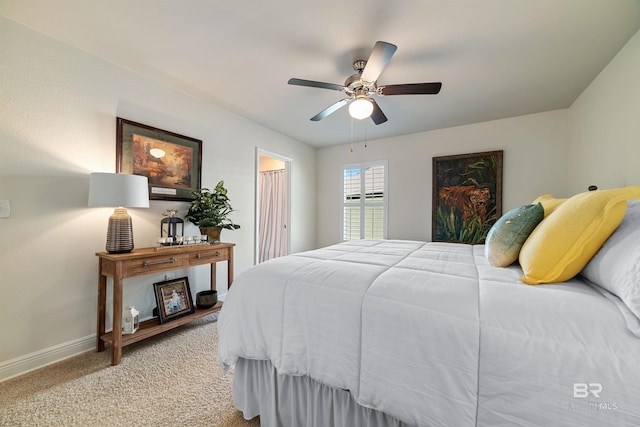 bedroom featuring light colored carpet, ceiling fan, and baseboards