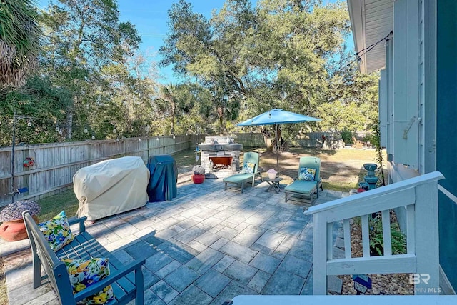 view of patio with area for grilling and a fenced backyard