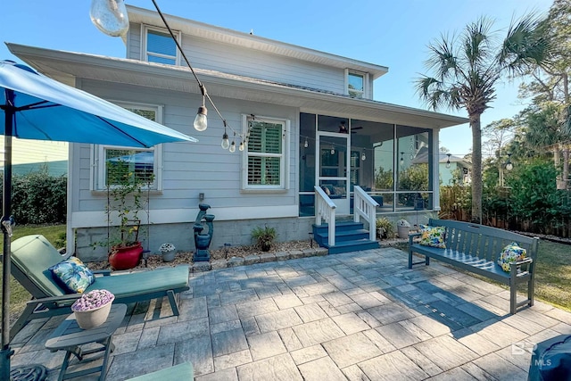 back of house featuring a sunroom and a patio