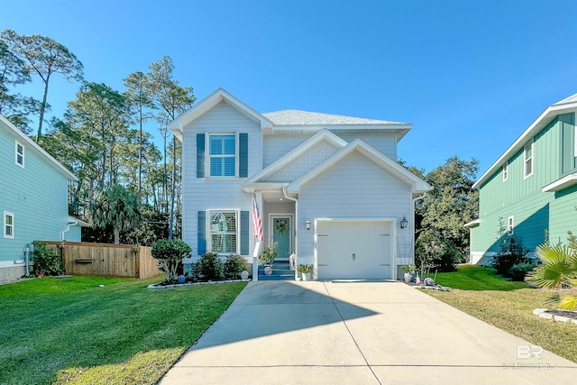 traditional-style house with a front yard, concrete driveway, fence, and an attached garage