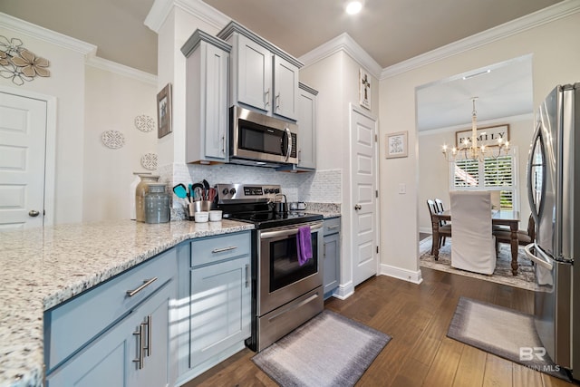 kitchen featuring appliances with stainless steel finishes, dark wood-style flooring, ornamental molding, and gray cabinetry