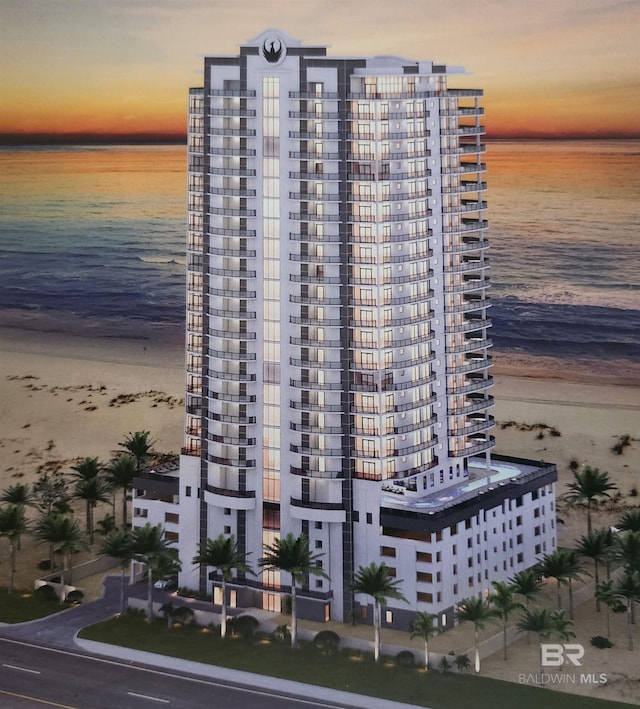 view of property with a water view and a view of the beach