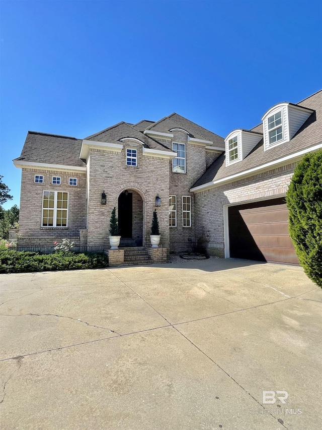 french provincial home featuring a garage