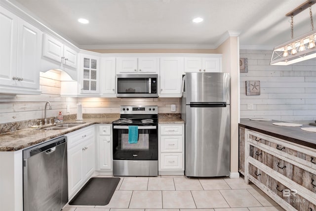 kitchen featuring sink, white cabinets, ornamental molding, and appliances with stainless steel finishes