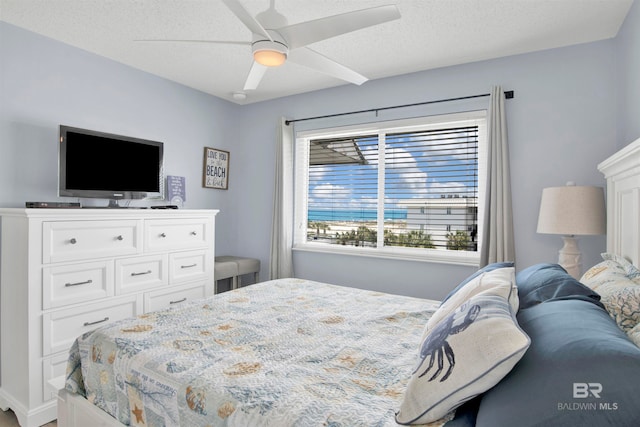 bedroom with a textured ceiling and ceiling fan