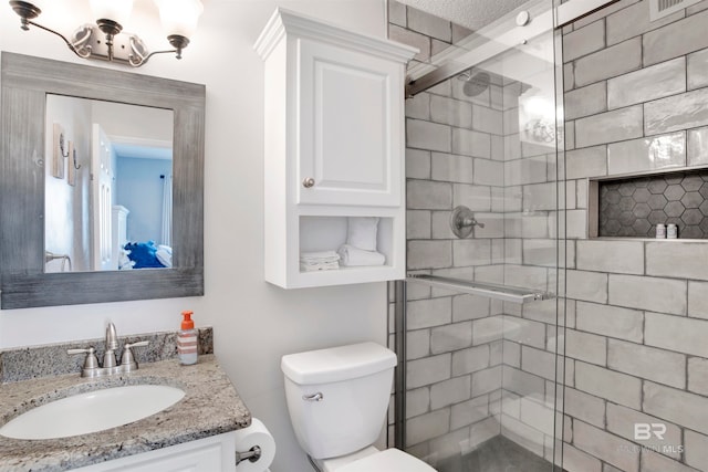 bathroom featuring a shower with door, a textured ceiling, toilet, and vanity