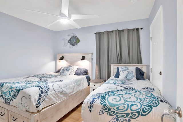 bedroom featuring ceiling fan and light hardwood / wood-style flooring