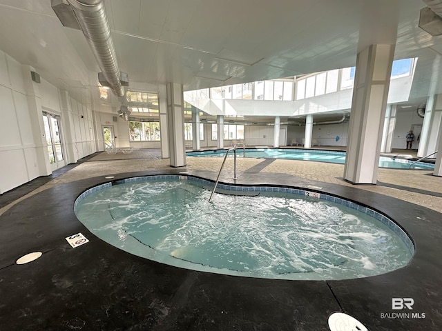 view of pool with an indoor hot tub