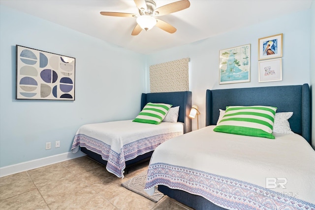 bedroom with ceiling fan and tile patterned flooring