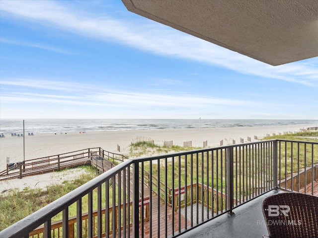 balcony with a view of the beach and a water view