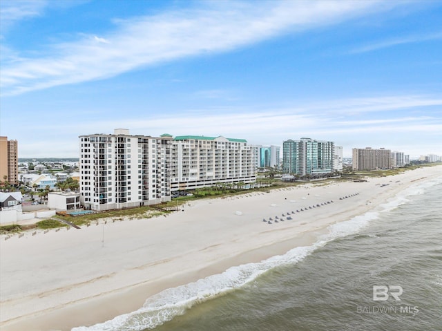 birds eye view of property with a beach view and a water view