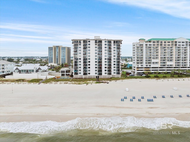 drone / aerial view featuring a water view and a beach view