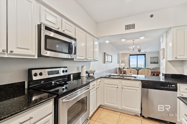 kitchen with white cabinetry, sink, and stainless steel appliances