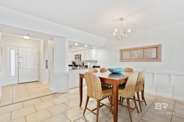 tiled dining space with a notable chandelier