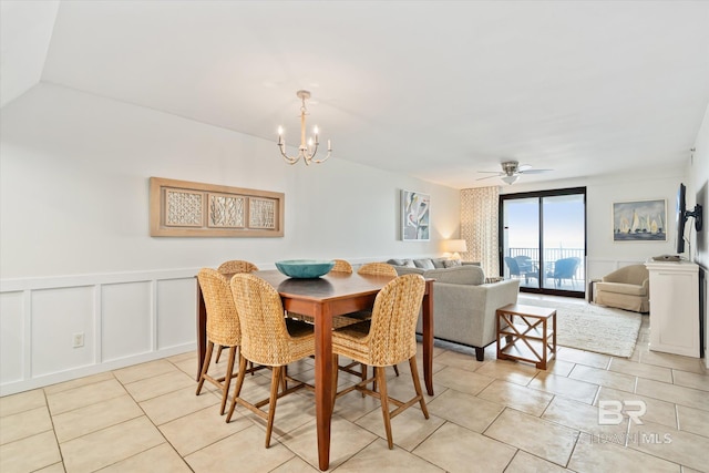 dining area with light tile patterned floors and ceiling fan with notable chandelier