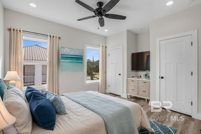 bedroom featuring light wood-type flooring and ceiling fan