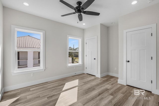 unfurnished bedroom featuring light wood-type flooring and ceiling fan