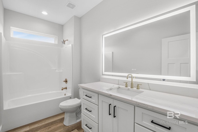 full bathroom featuring shower / bath combination, hardwood / wood-style flooring, vanity, and toilet