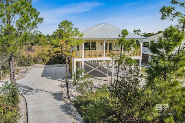 rear view of property with a carport and covered porch