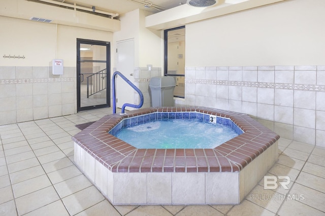 view of swimming pool with an indoor hot tub