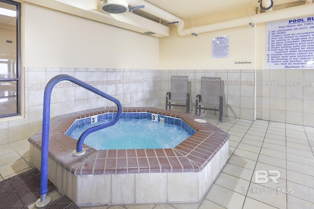 view of pool with an indoor hot tub