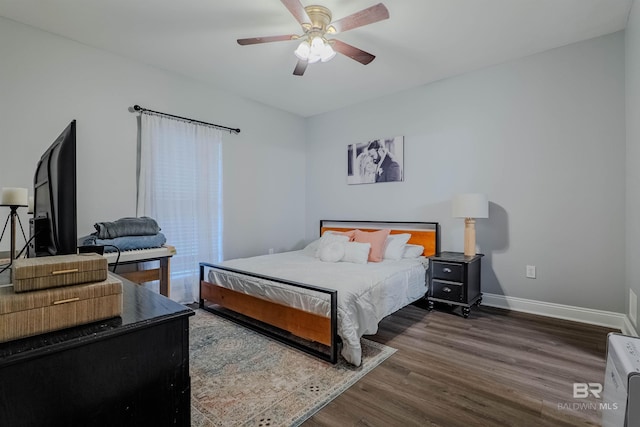 bedroom with ceiling fan and dark hardwood / wood-style floors