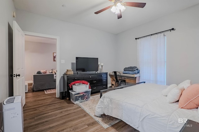 bedroom featuring ceiling fan and dark hardwood / wood-style floors