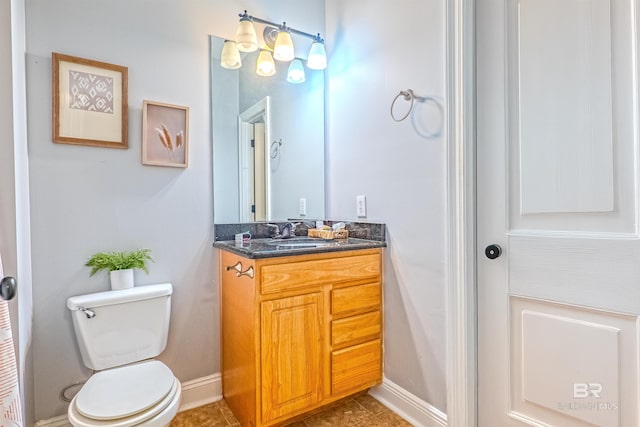 bathroom featuring tile patterned floors, vanity, and toilet