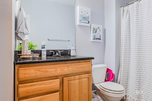 bathroom with vanity, toilet, and walk in shower