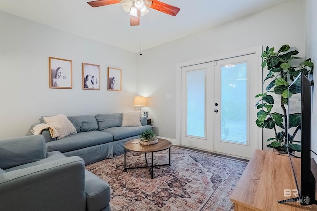 living room featuring hardwood / wood-style flooring, ceiling fan, and french doors