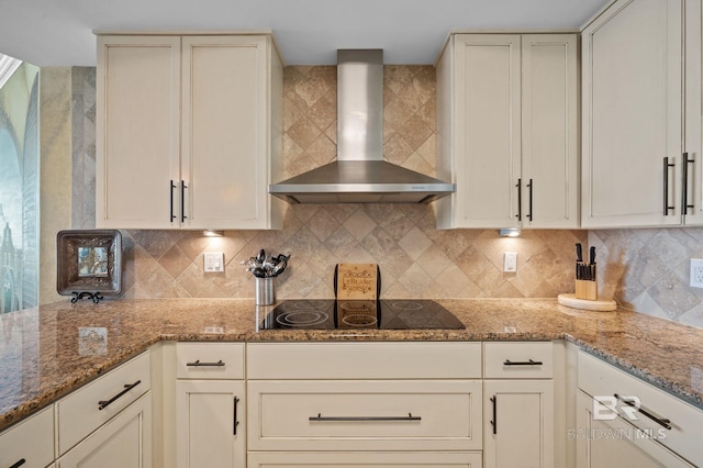 28107 Perdido Beach Blvd Unit D914, Orange Beach, AL 36561 - kitchen featuring black electric stovetop, wall chimney exhaust hood, decorative backsplash, and light stone countertops