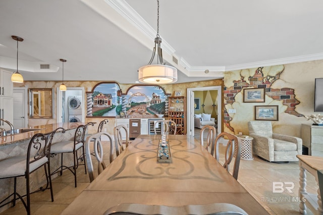 28107 Perdido Beach Blvd Unit D914, Orange Beach, AL 36561 - dining room with visible vents, stacked washer / drying machine, and crown molding