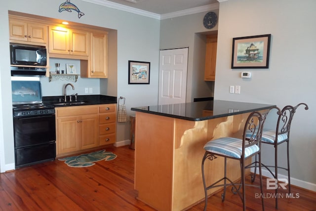 kitchen featuring dark wood finished floors, a peninsula, crown molding, black appliances, and a sink