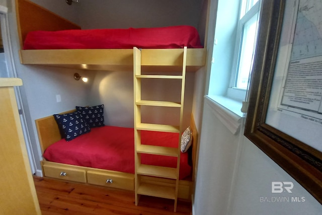 bedroom with wood finished floors