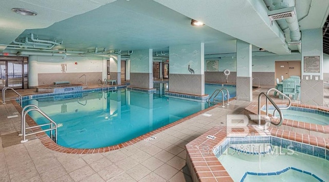 view of swimming pool featuring an indoor hot tub